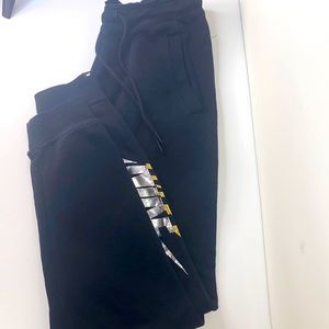 Nike sweatpants black with gold and silver